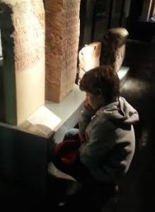 My son studying Latin inscriptions in the Cologne Praetorium exhibition. – (c) PK, 2014.